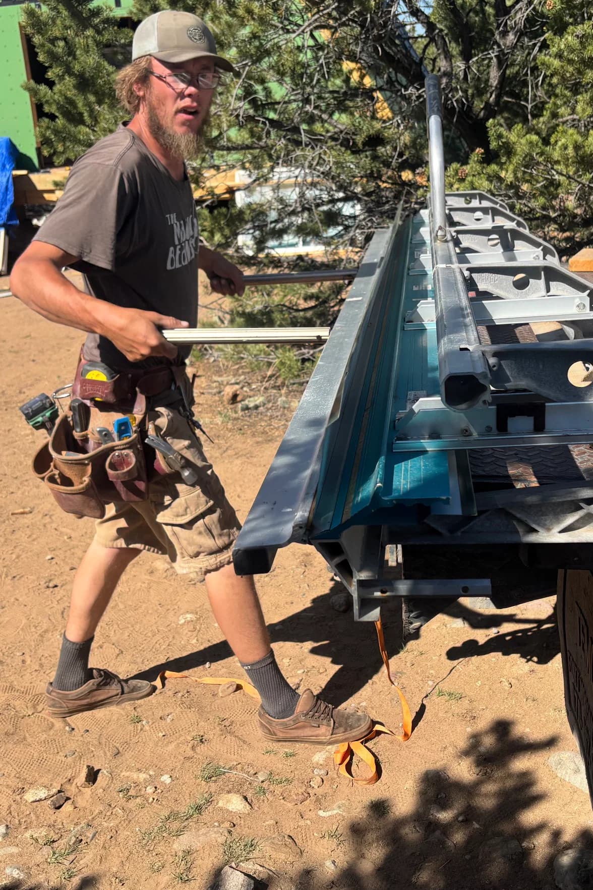 Joshua handling metal trim beside a portable metal brake.