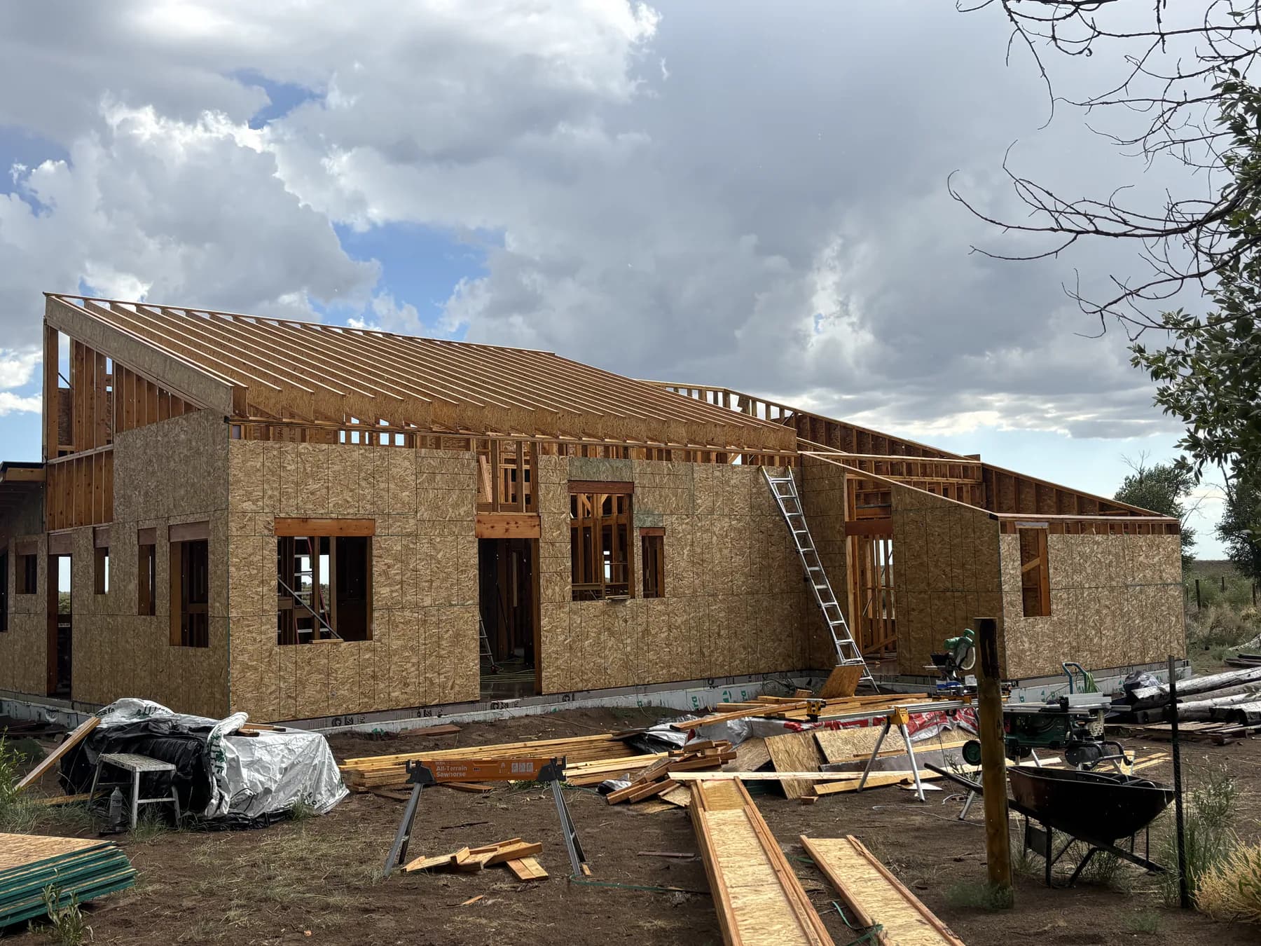 A new home under construction with roof framing in progress.