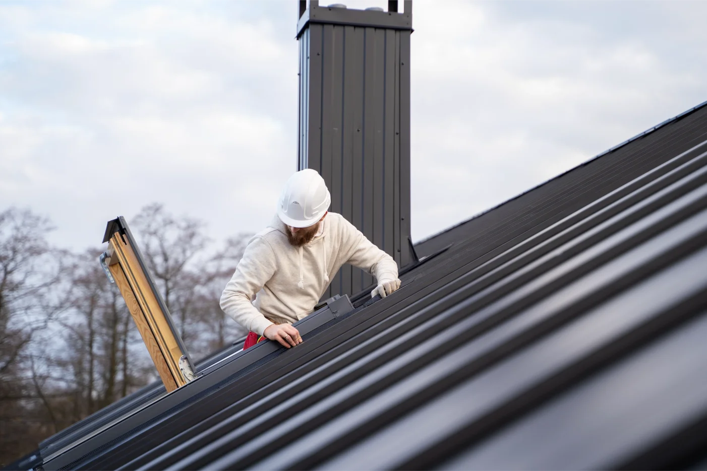 Medium shot of a man working on a metal roof