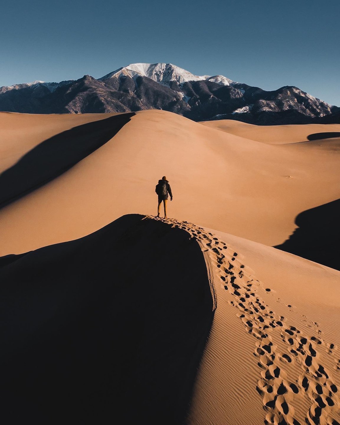 A person walking through the Great Sand Dunes National Park